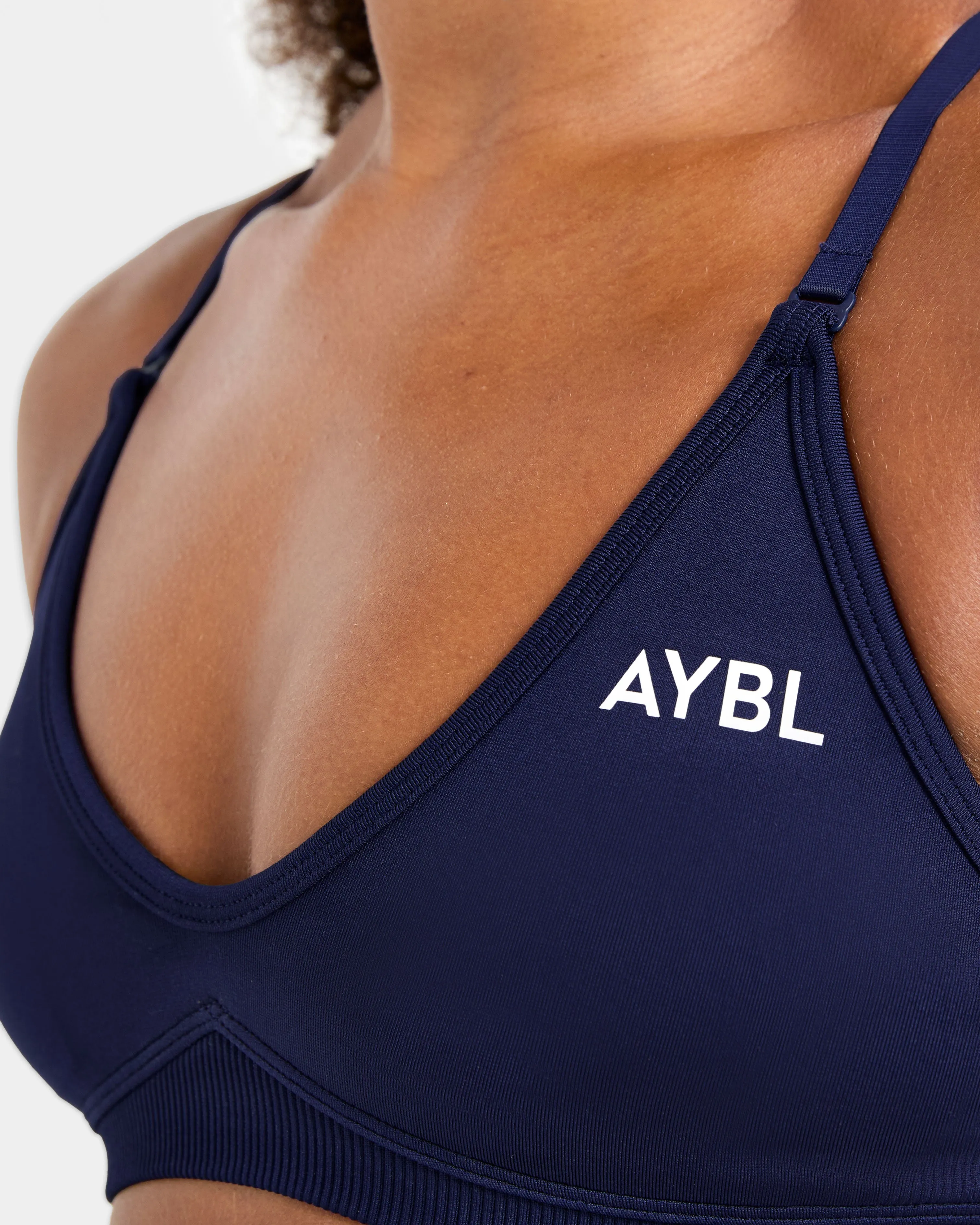 Adapt Seamless Strappy Sports Bra - Deep Navy Orange sports apparel Seamless Comfort
